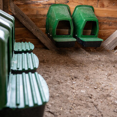 Empty nesting boxes in a chicken coop, clean setup for egg laying, free-range non-cage poultry farming in a rural environment. © Marek