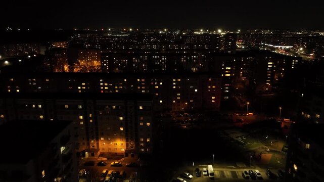 Aerial Night Shot of Soviet Panel Apartment Blocks during winter season in a residential area.