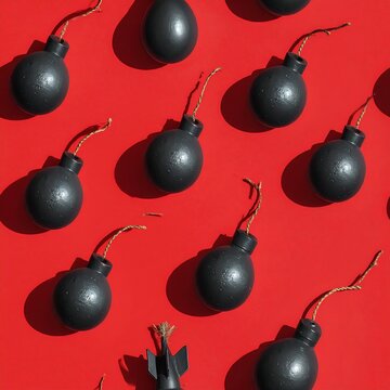 A red background with a pattern of black bomb-like objects