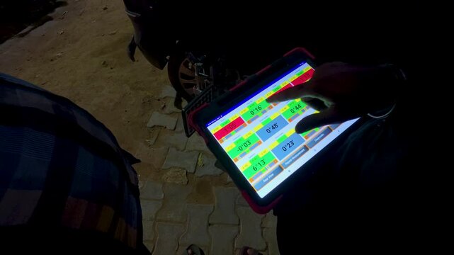 Mechanic performing car wheel alignment using tablet stock video footage.
