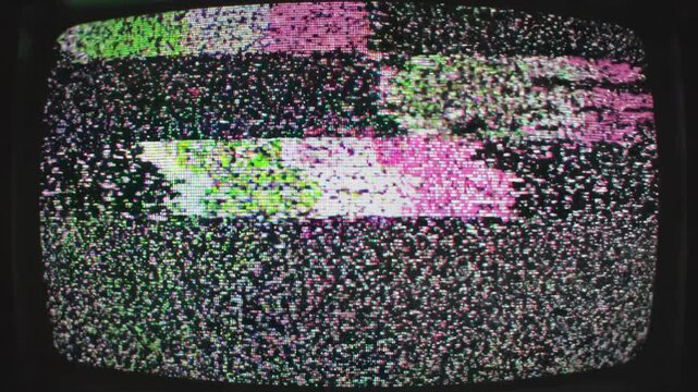 Glitch noise static with television screen effect concept. Close up of retro television screen showing colorful static and noise with green pink and black pixels