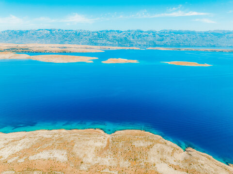 Vrsi near Zadar archipelago cove beach in stone desert scenery near Zecevo island, Dalmatia in Croatia and Pag Island in background.