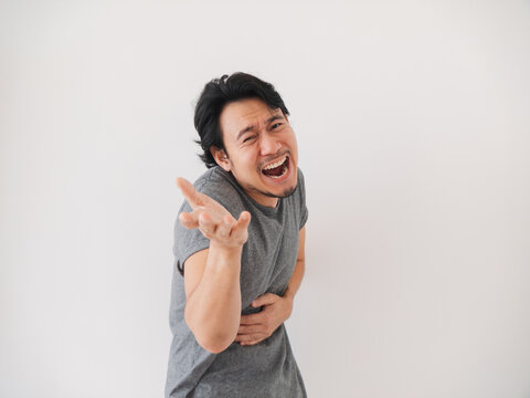 Reaction of Asian man laughing of what in front of him, isolated on white.