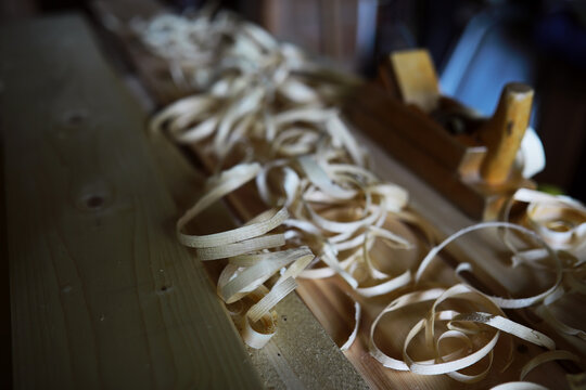 Plane jointer carpenter or joiner tool and wood shavings. Woodworking tools on wooden table. Carpentry workshop