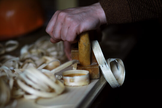 Plane jointer carpenter or joiner tool and wood shavings. Woodworking tools on wooden table. Carpentry workshop