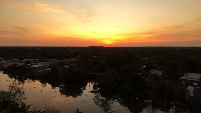 Thanh My and My Loi, Dong Thap province (Tien Giang), Mekong Delta, Vietnam: 4K aerial drone footage of canal waterways, rural houses, boats, tropical farmland and river landscape at golden sunset