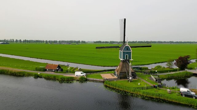 Traditional Dutch windmill in a rural holland lush green landscape