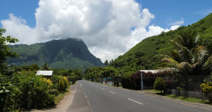 Papetoai, island of Moorea, French Polynesia.Mount Rotui covered by clouds in the background.
