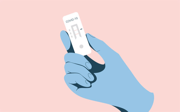 Hand in blue glove holding a positive covid-19 rapid antigen test