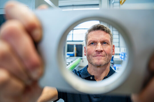 Employee inspecting product in industrial setting during review