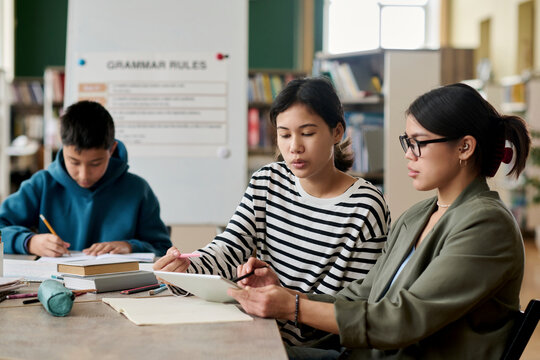 Student asking teacher a question during an intercultural group class