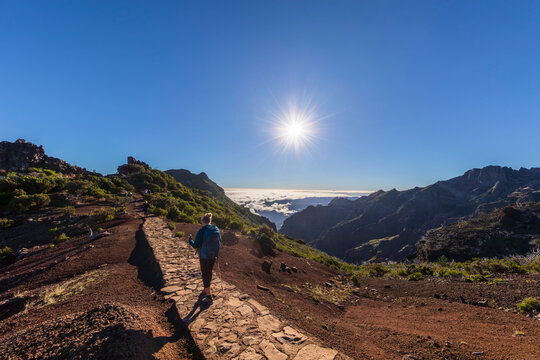 Tourist hiking on scenic Pico Ruivo trail in Madeira Portugal