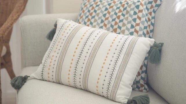 Minimalist living room sofa decorated with stylish pillows showing slow zoom out movement.