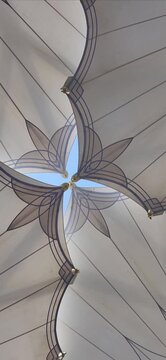 Ornately designed large umbrellas at Al-Masjid an-Nabawi, Medina, Saudi Arabia, feature geometric patterns. Made from durable fabric, they provide shelter and shade. The umbrellas are mounted on tall,