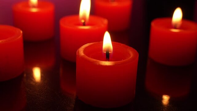 Red small Candles shown In A Dark red Room
