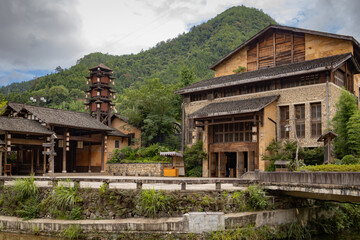 Obraz premium Traditional building at the mountain village along rocky cliffs in Wangxian Valley, Shangrao, Jiangxi, China