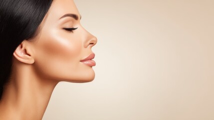 Fototapeta premium Studio portrait of young woman with natural makeup, combed hair, touching well-groomed pure skin on face, isolated on blue background. Beauty, facelift, anti-aging cosmetic procedure. Banner.