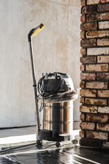 Industrial wet and dry vacuum cleaner in renovating room Professional vacuum cleaner in renovation interior for dust and debris removal