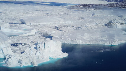 Icebergs drifting in Arctic fjord with mountains in background © tora_72