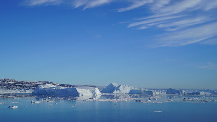 Icebergs in Arctic ocean under cloudy sky, Greenland landscape © tora_72