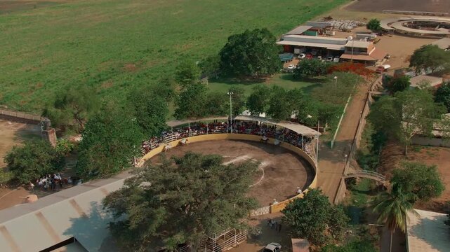 Scaramuza event in Colima, Mexico. Aerial dolly in approaching circular arena during rodeo cultural performance