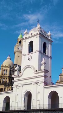 Vertical panning Cabildo Buenos Aires colonial clock tower building with skyline Argentina historic landmark space for text