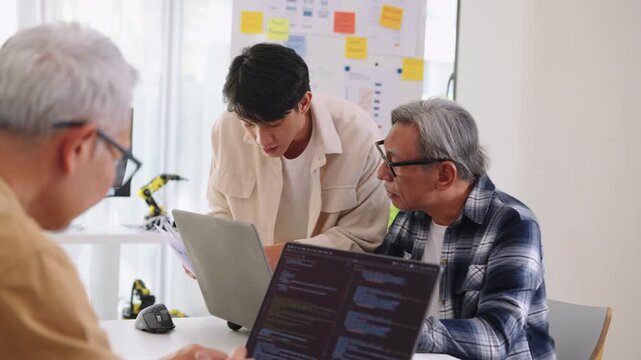 Asian Instructor Teaching Senior in Software Programming and Training Collaboration