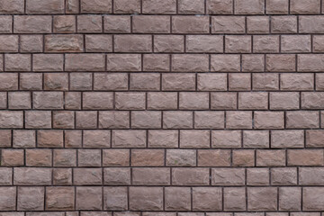 Fototapeta premium Brick wall with regular pattern and rough texture outdoors