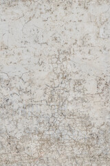 Obraz premium Cracked paint texture on a weathered white wall surface