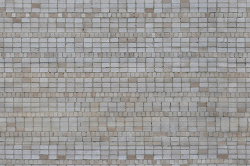 Fototapeta premium Mosaic tile wall with light beige and gray square patterns