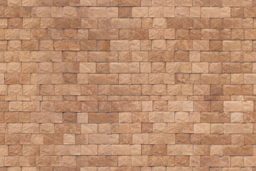 Fototapeta premium Textured brown brick wall surface with rough finish indoors