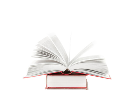 Stack of books and one opened book on top in the middle front view isolated white background space for text copy space macro