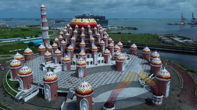 Aerial Coastal View of 99 Domes Mosque in Makassar by Losari Waterfront with CPI makassar as background, masjid kubah 99 makassar.