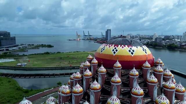 Aerial Coastal View of 99 Domes Mosque in Makassar by Losari Waterfront with CPI makassar as background, masjid kubah 99 makassar.