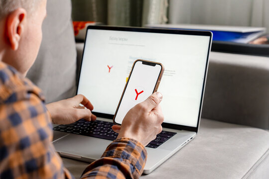 A man holds a smartphone with the Yandex browser app. Saint Petersburg, Russia - 7 Apr 2026