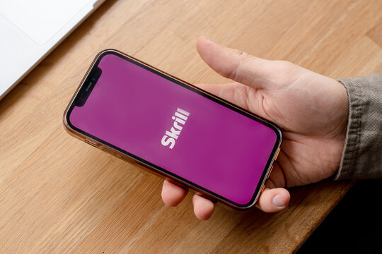 A man holds a smartphone with the Skrill app. Saint Petersburg, Russia - 7 Apr 2026