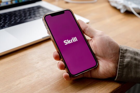 A man holds a smartphone with the Skrill app. Saint Petersburg, Russia - 7 Apr 2026