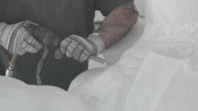 Sculptor Working on Marble with Chisel Close View