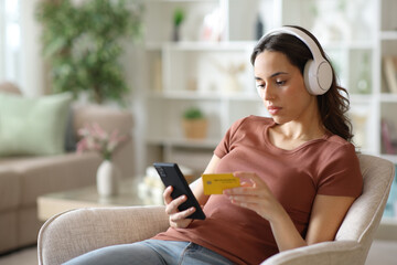 Woman wearing headphone paying media online