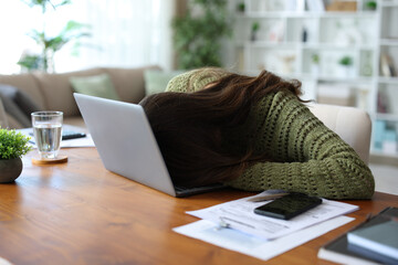 Teleworker sleeping on a laptop working at home