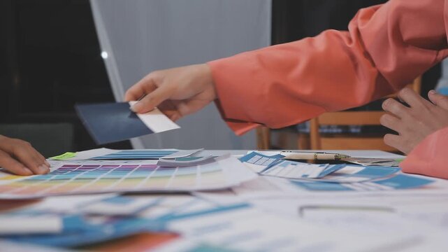 Asian uxui designer working on website design using sticky notes and wireframes