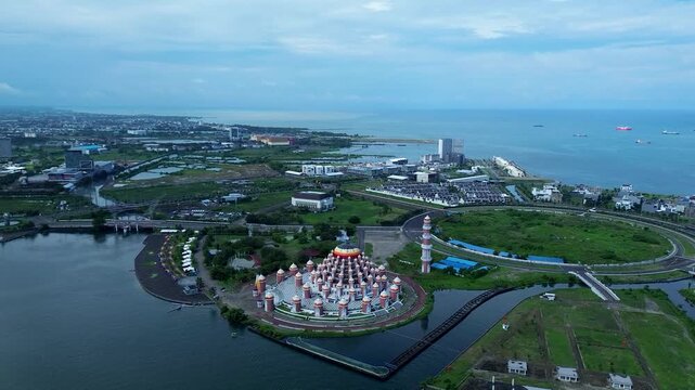Aerial Coastal View of 99 Domes Mosque in Makassar by Losari Waterfront with CPI makassar as background, masjid kubah 99 makassar.