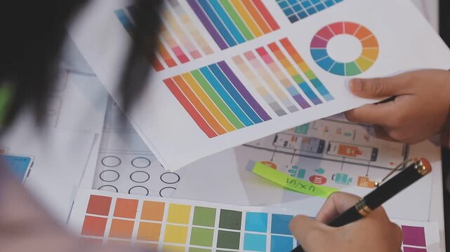 Asian uxui designer working on website design using sticky notes and wireframes