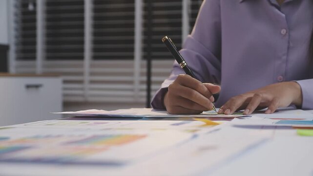 Asian uxui designer working on website design using sticky notes and wireframes