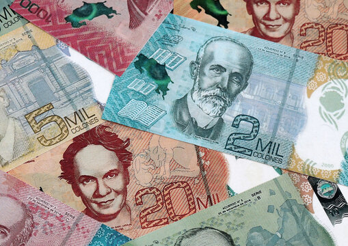 Costa Rican new colon money banknotes pile on table. Costa Rica bills of CRC currency close up