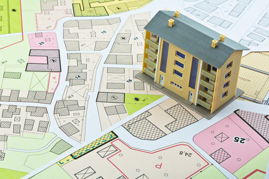 Imaginary cadastral map and general urban plan with cadastral parcels, urban destinations, vacant land plots and condominium residential building
