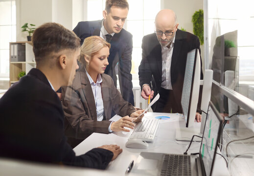 Team colleagues office meeting planning strategy analysis. Managers review a tablet and charts, discuss metrics, align goals and refine the project roadmap. Data driven teamwork for decisions.