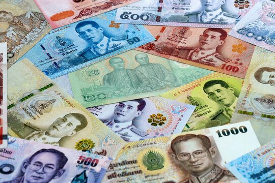 Thai baht money banknotes pile on table. Thailand bills of THB currency close up. Concept of economy
