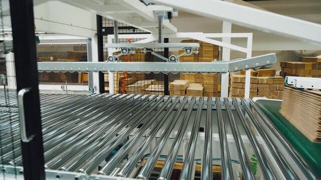 Automated packaging process. Hightech machinery ensures precise packaging in manufacturing plant. Automated sorting and handling systems optimize packaging efficiency and sustainability in industry
