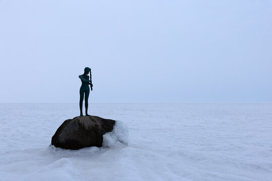 Kaysa sculpture on rock at frozen Baltic Sea in Baabe R�gen during winter